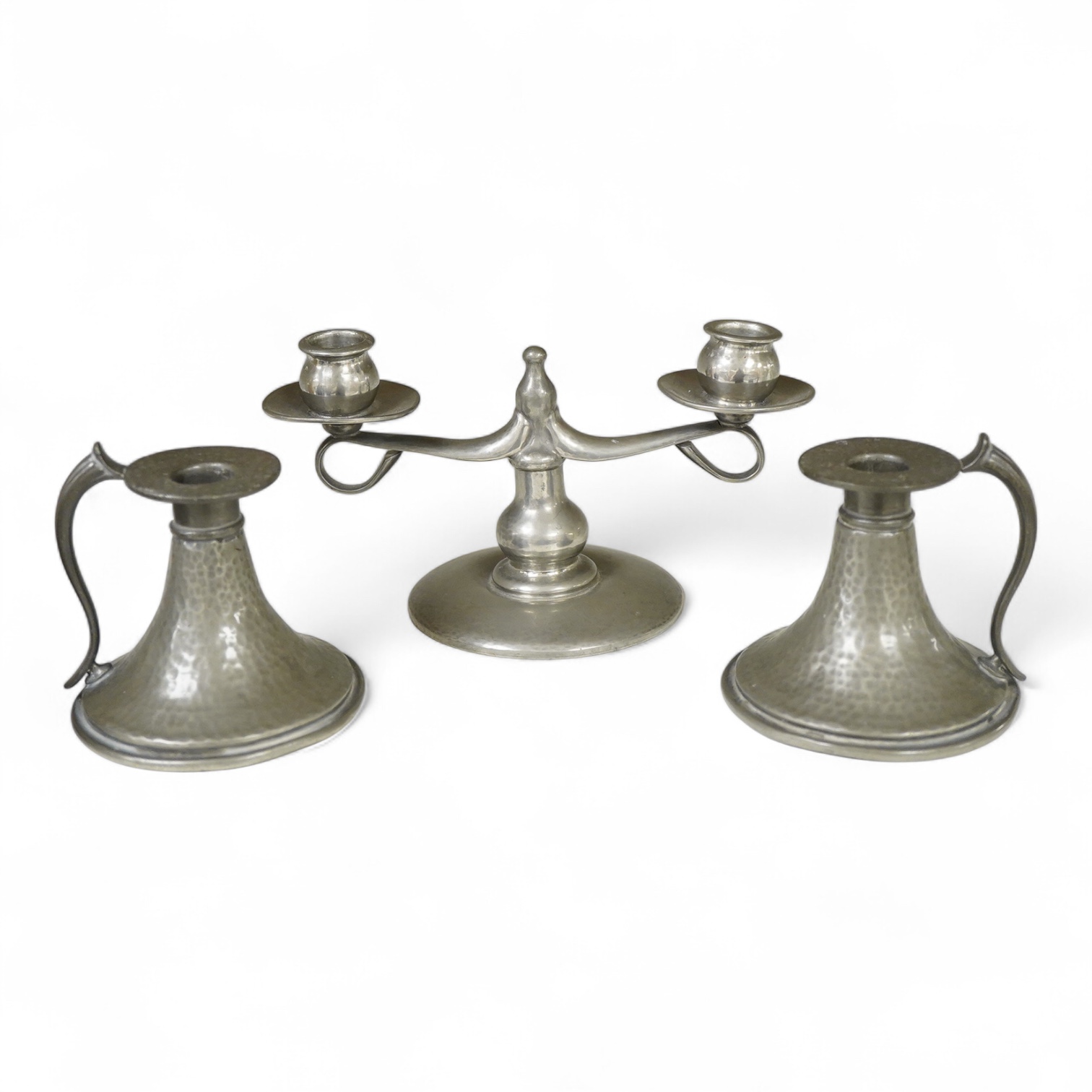 A Liberty Tudric pewter two branch candlestick, 22cm wide and two hammered candle holders.